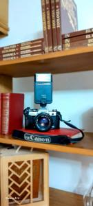 a camera sitting on top of a book on a shelf at Habitación 4 en Casa Retro in Medellín +18 photos