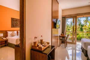 Postel nebo postele na pokoji v ubytování Kahayana Suites Ubud