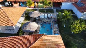 an overhead view of a swimming pool with umbrellas at POUSADA ESTRELA DA MANHÃ in Barreirinhas