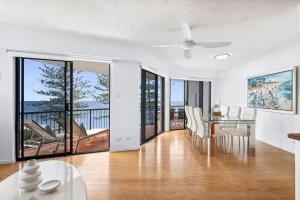 a dining room with a ceiling fan and a dining table at Unit 8 'The Rocks' in Coolum Beach