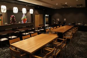 a row of tables and chairs in a restaurant at Hotel Abest Hakuba Resort in Hakuba