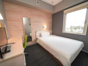 Postel nebo postele na pokoji v ubytování Super Hotel Kofu Showa Inter