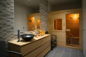 a bathroom with a bowl sink on a wooden counter at Olé Tropical Tenerife Adults Only in Playa de las Americas
