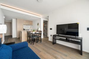 a living room with a blue couch and a table at Luxury High-Rise Condo with Stunning Views in Vancouver