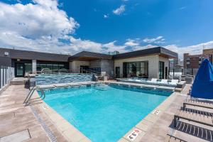 a large swimming pool with chairs and a building at Impeccable1B Salt Palace & Delta - PoolSpaGymPrkgViews in American Towers Condominium