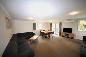 a living room with a couch and a table at Sunseekers at Hat Head - 44 Bay Street in Hat Head