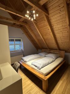 a bedroom with a large bed in a attic at Das Landhotel zur Mühle in Münster