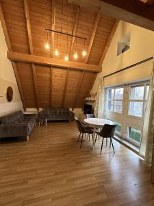 a large living room with a table and chairs at Das Landhotel zur Mühle in Münster +26 photos