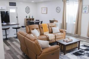 a living room with a couch and a table at TSDLS Hometel in Smithfield