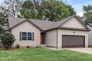 a white house with a garage at The Gate 4 Getaway! in Oak Grove