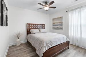 a bedroom with a bed with a ceiling fan at The Gate 4 Getaway! in Oak Grove