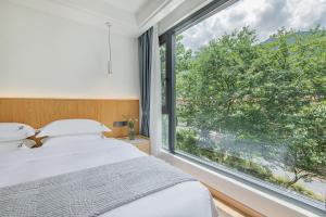 เตียงในห้องที่ 安吉季意民宿 Jiyi Boutique Homestay, Anji, Huzhou