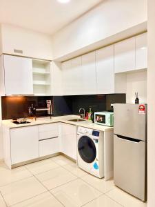 a kitchen with a washing machine and a refrigerator at KUROMI Theme Suite for Families- 3min drive Legoland & EcoBotanic in Nusajaya +92 photos