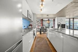 a kitchen with white appliances and a dining room at Modern Condo in downtown two bedroom parking lot in Vancouver