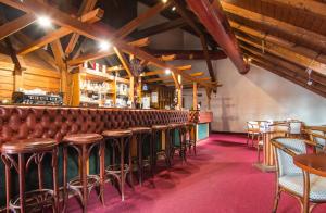 a bar with a lot of chairs and tables at Appartaments Lavaredo in Carbonin
