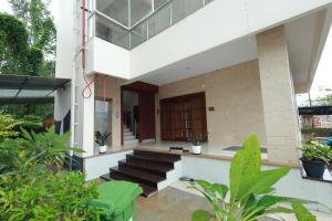a view of a house with stairs and a door at Swami Prasad Paradise hotel in Golitattu