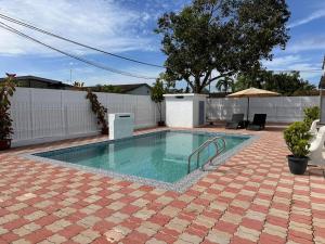 a swimming pool in a yard with a patio at Rumah Mawar in Arau