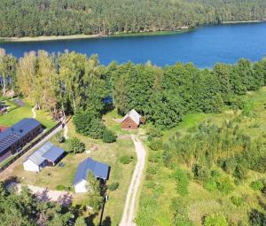 an aerial view of a house and a lake at Ažuluokesos sodyba in Molėtai +32 photos