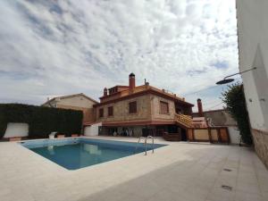 a large house with a swimming pool in front of it at Villa Family Kids "Joropillo" - Full house rent in Bejarín