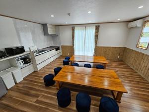 a room with a table and chairs and a kitchen at Forest minami kawaguchiko in Fujikawaguchiko +19 photos