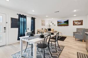 a dining room and living room with a white table and chairs at Lovely Apt 5mins from Big Tex Free Prk in Dallas