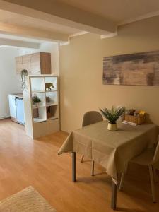 a living room with a table and a kitchen at Gemütliche Appartement 4 - mit Küche und Bad zur Eigennutzung -Schuster Homes- in Alvesse