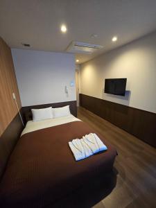 Postel nebo postele na pokoji v ubytování Hotel Ekichika Nagahoribashi + 15 fotografií