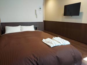 Postel nebo postele na pokoji v ubytování Hotel Ekichika Nagahoribashi