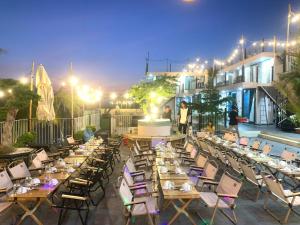 a restaurant with tables and chairs on a patio at night at Queen Sea Resort - Đảo Phú Quý in Cu Lao Thu
