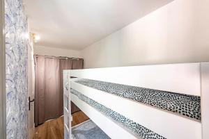 a white bedroom with a bunk bed in it at LE CAP - Superbe appartement, proche Monaco in Roquebrune-Cap-Martin +20 photos