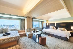 a hotel room with a bed and a large window at Cerulean Tower Tokyu Hotel, A Pan Pacific Partner Hotel in Tokyo