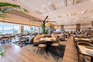 an image of a restaurant with tables and chairs at Grand Mercure Beppu Bay Resort & Spa in Beppu