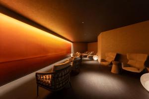 a waiting room with chairs and a table and lights at Grand Mercure Beppu Bay Resort & Spa in Beppu