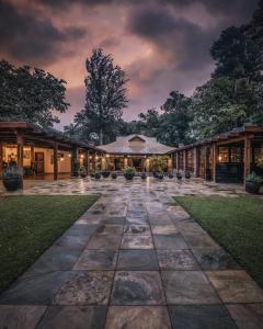 an empty courtyard of a building at night at Elewana Arusha Coffee Lodge in Arusha