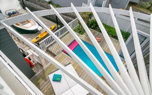 an overhead view of a swimming pool seen through a white fence at Turbine Villa in Knysna