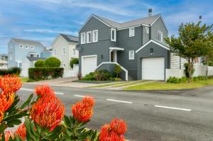 a house with orange flowers in front of a street at Turbine Villa in Knysna