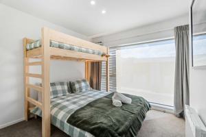 a bedroom with a bunk bed and a window at Mt Roy Delight in Wanaka