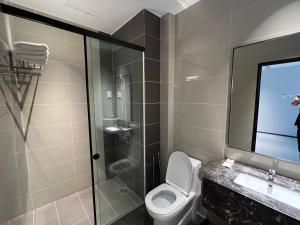 a bathroom with a toilet and a glass shower at Teamwork Melaka Cozy Apartment in Ayer Keorh in Malacca
