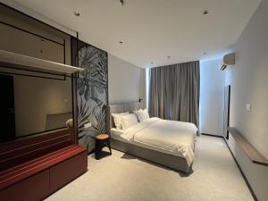 a hotel room with a bed and a television at Teamwork Melaka Cozy Apartment in Ayer Keorh in Malacca