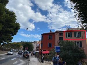 a busy city street with people walking on the sidewalk at Le charme de Collioure in Collioure