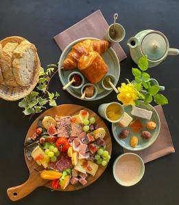 a table topped with plates of food and bread at Appartement cosy in Sahorre +23 photos