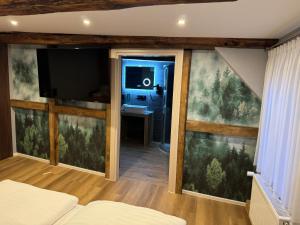 a bedroom with sliding glass doors and a tv at Goldener Stern in Goslar