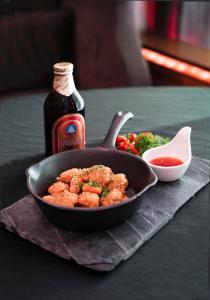 a pan of food and a bottle of sauce on a table at Radisson Collection Hyland Shanghai in Shanghai