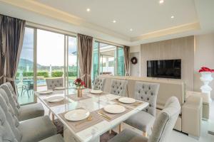a dining room with a table and chairs at Luxurious 4-Bedroom Pool Villa Best Mountain Views in Hua Hin