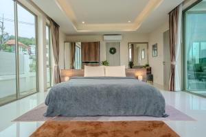 a bedroom with a large bed and large windows at Luxurious 4-Bedroom Pool Villa Best Mountain Views in Hua Hin +31 photos