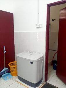 a bathroom with a water heater in a room at Homestay Atikah Bahau in Bahau