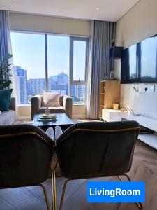a living room with a couch and a table at Spacious 2BR APT Near Sandton City -No Loadshedding in Johannesburg +67 photos