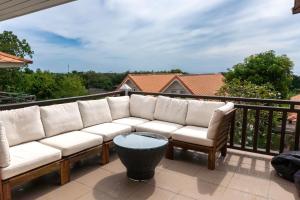 a white couch sitting on a balcony at Lanna Lanta in Phra Ae beach