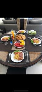 a table with plates of food on top at Koh Samui Lifestyle Private Luxury Beach Front Villas in Plai Laem