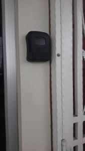 a door with a black box on the side of it at HomestayLj Gurun in Kampung Gurun +10 photos